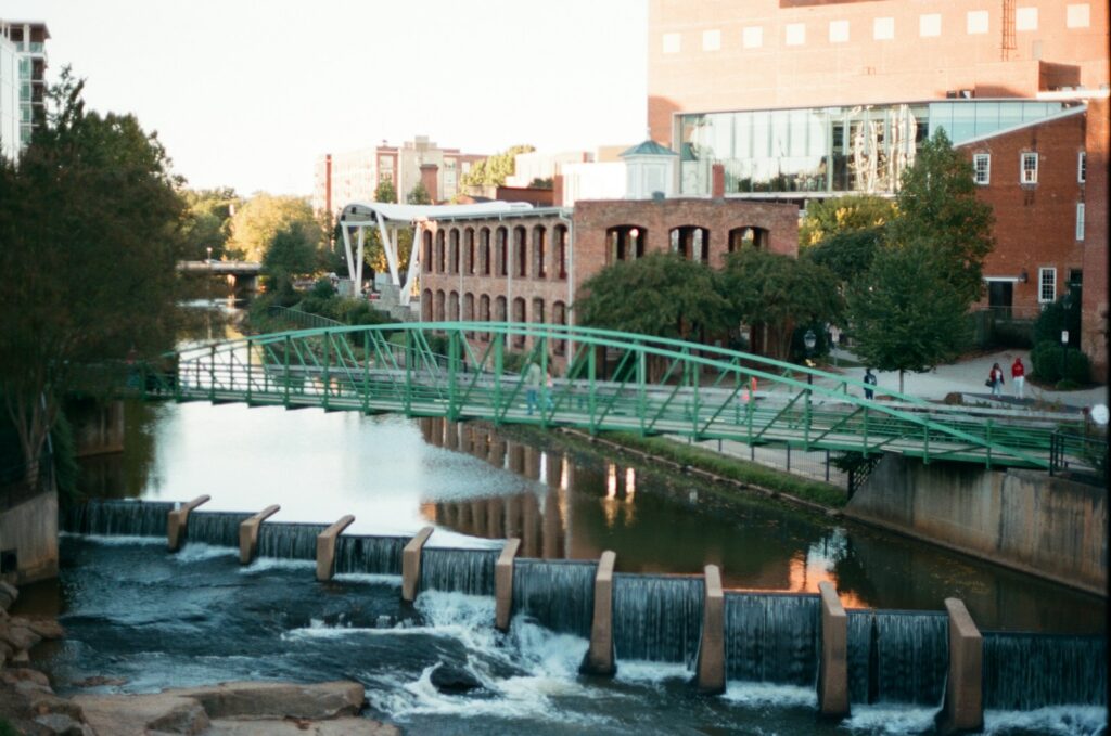 greenville travel destination for couples water falls near green bridge during daytime